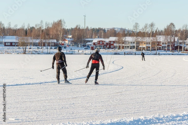 Obraz three people skating on a frozen lake