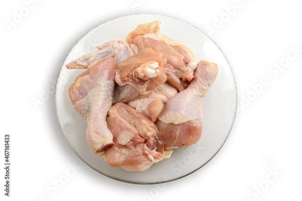 Fototapeta Raw chicken meat on a plate. Isolated on a white background.The view from the top. Healthy eating
