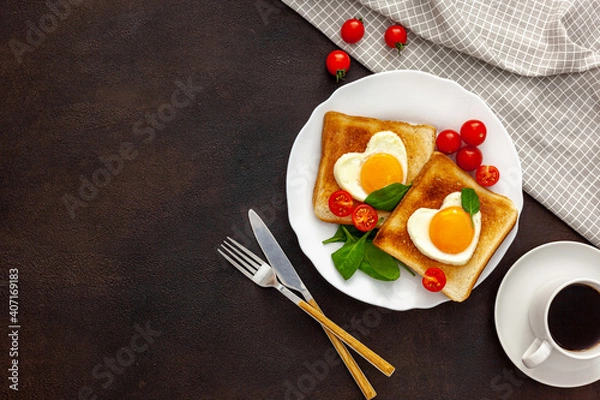 Fototapeta Scrambled eggs in the form of heart on plate with tomatoes, greens and coffee