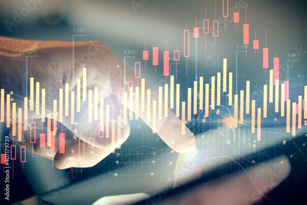 Fototapeta Multi exposure of man's hands holding and using a phone and financial chart drawing. Market analysis concept.