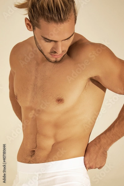 Obraz Sexy sport muscle strongface blond guy with long hair in white underwear on white isolated  font background