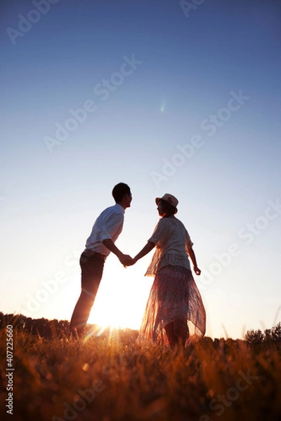 Obraz Young couple walking hand in hand