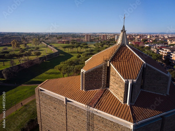 Obraz The cross of San Policarpo church in the foreground. In the background the skyline of Rome near Parco degli Acquedotti park, one of the largest and oldest park of the city.