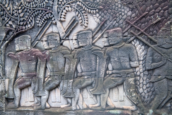 Fototapeta   Bayon the central temple of Angkor Thom, late 12th century. Bas-relief. It rains in the rainy season. (Cambodia, 04.10. 2019)
