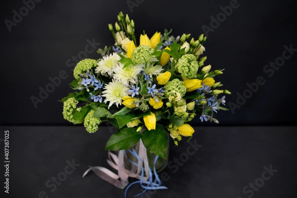 Fototapeta A bouquet of bright, juicy flowers on a dark background. Spiral assembly technique without decorative packaging.