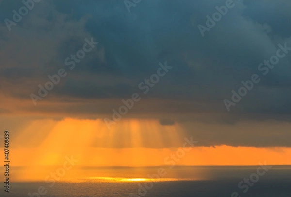 Fototapeta Sunbeams in the sea breaking through the clouds.Concept elements of Nature