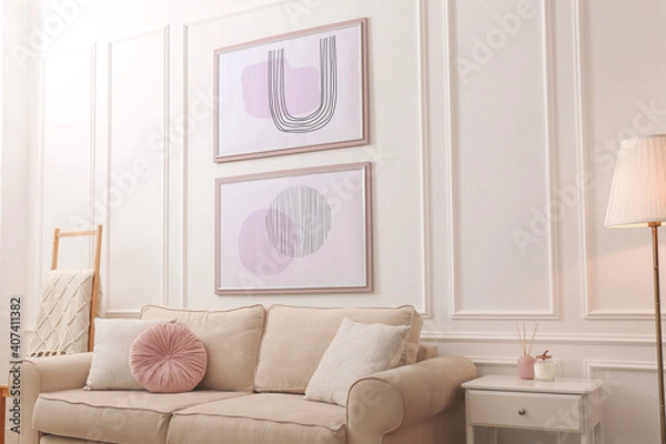 Fototapeta Stylish living room interior with comfortable sofa and pictures