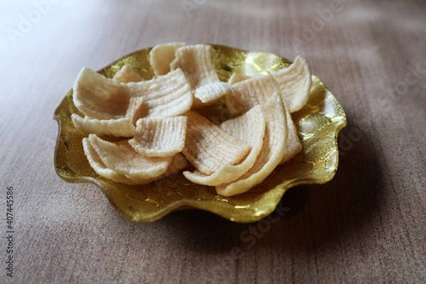 Fototapeta crackers, traditional Indonesian snacks, on small gold plates