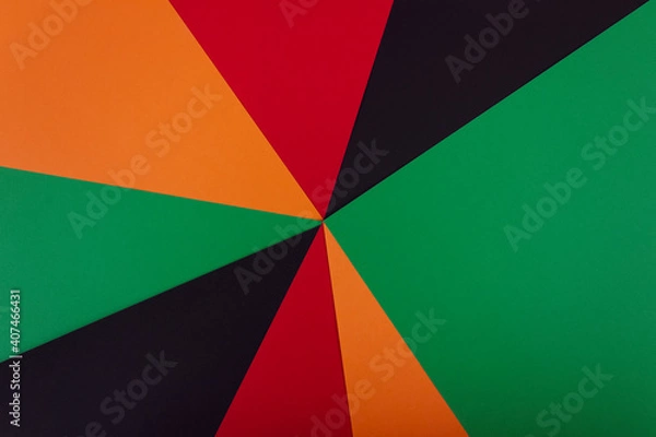 Fototapeta Red, yellow and green color paper on the black background. Black History Month concept. Flat lay. Copy space.