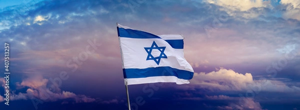Fototapeta Israeli flag with a star of David over Jerusalem at cloudy sky background on sunset, panoramic view.