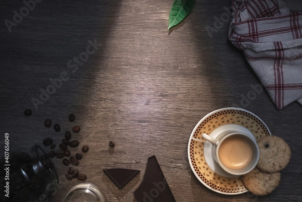 Fototapeta Cup of espresso with roasted coffee beans, the sun is lighting through the window. Top Down view and copy space for text.