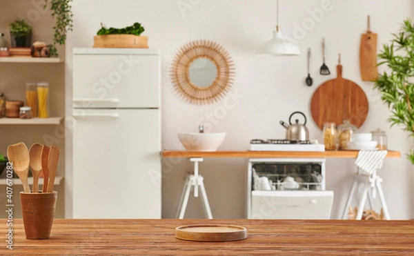 Fototapeta Close up wooden table and decorative kitchen background style. Refrigerator, dishwasher and stove style with lamp concept.