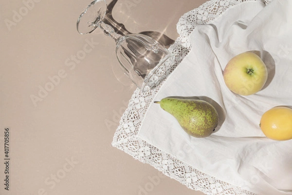 Fototapeta Summer still life composition made of fruits and glass on white cloth. Creative background. Freshness concept. Top view. Flat lay. Copy space