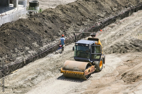 Obraz vibratory soil compactors at a construction site preparing the soil