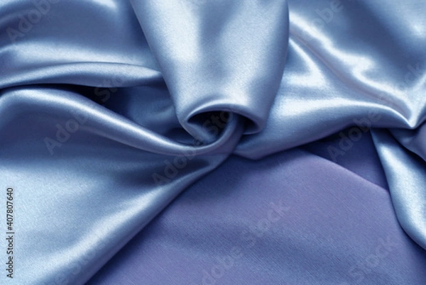 Fototapeta Smooth delicate blue silk or satin fabric for background. Delicate folds. Close-up.