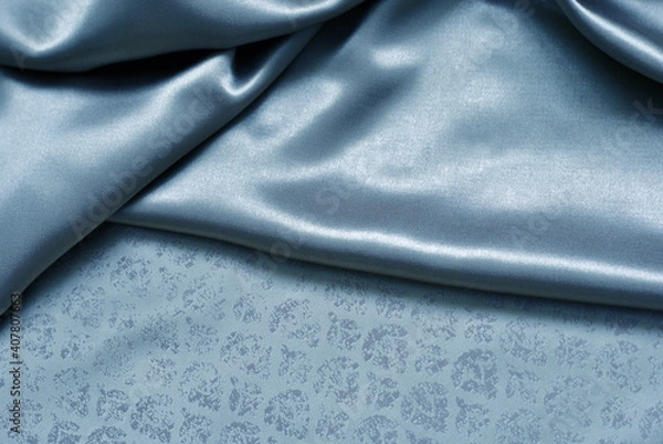 Fototapeta Smooth delicate blue silk or satin fabric for background. Delicate folds. Close-up.