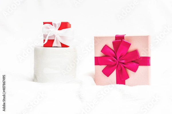 Fototapeta Toilet paper, two gifts for New year on a white background, artificial snow, copy space