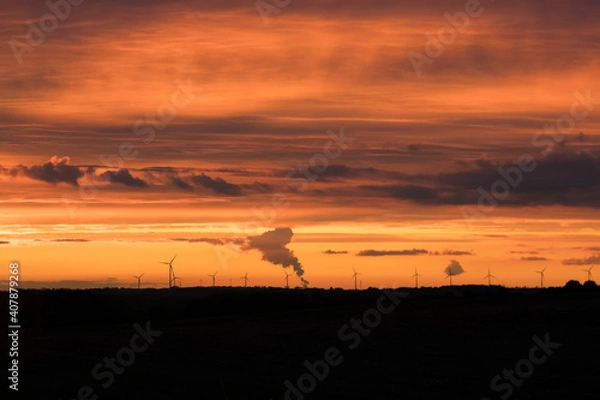 Fototapeta Sunset over windmills and fields

