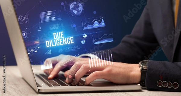 Fototapeta Businessman working on laptop with DUE DILIGENCE inscription, new business concept