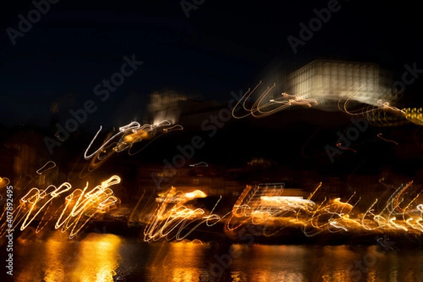 Fototapeta Light trails of the city of Portugal at night. Light motion blur. Out of focus image.