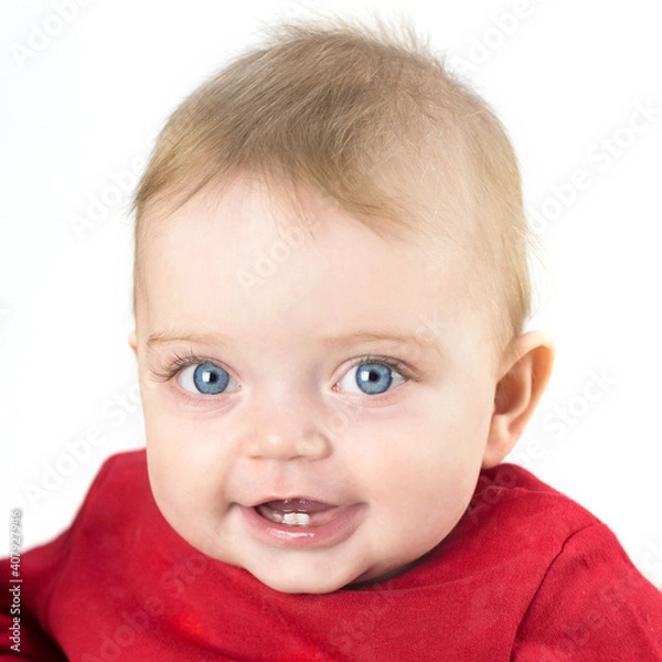 Fototapeta Six month old baby with big eyes and a beautiful smile on a white background.