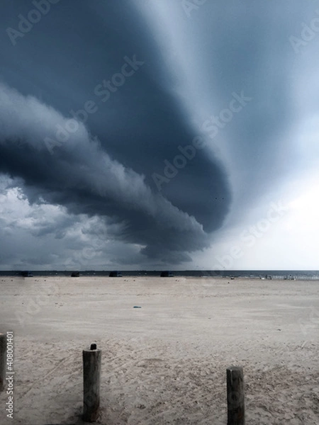 Fototapeta Storm clouds rolling over beach