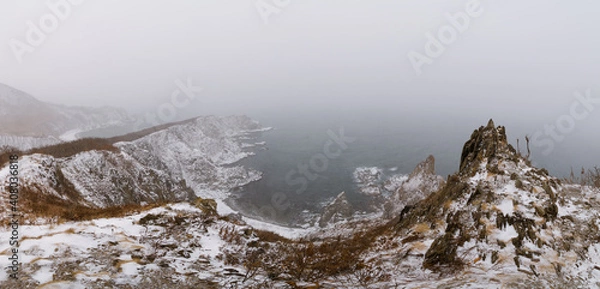 Obraz Snow storm over sharp sea cliffs
