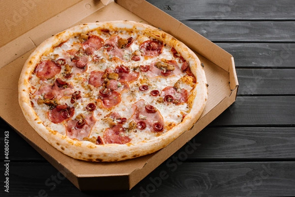 Obraz Delicious fresh pizza with meat and sausage on wooden background