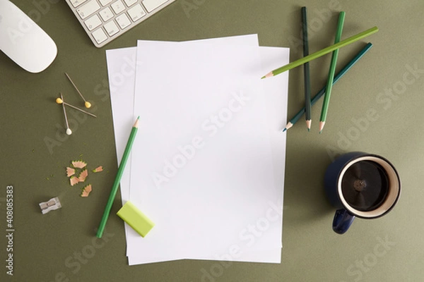 Fototapeta Green pencil, white paper and eraser. Empty place for text or drawing on the green background.