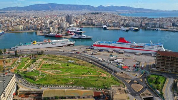 Fototapeta Aerial drone photo of busy port of Piraeus, the largest in Greece and one of the largest passenger ports in Europe as seen from old fertiliser factory, Attica, Greece 