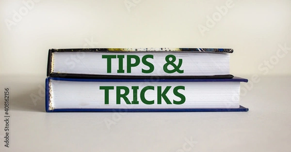 Fototapeta Tips and tricks symbol. Books with words 'Tips and tricks'. Beautiful white background. Business, tips and tricks concept. Copy space.