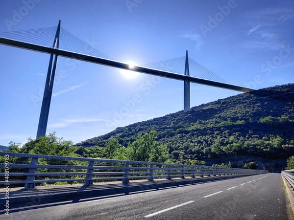 Obraz A summer panorama of a great white cable bridge. Bridge crossing the valley.  Natural panoramic view. Highest bridge. Bridge over the river