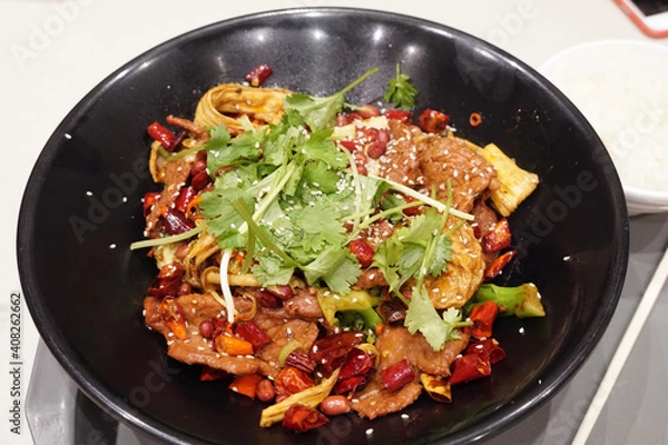 Fototapeta Mala Xiang Guo - Chinese popular dish, stir fried assorted mixed vegetables, mushroom and meat in hot chilli seasoning on big black bowl