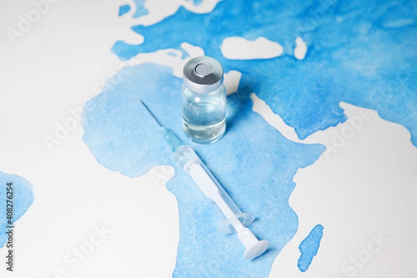 Obraz Bottle of coronavirus vaccine and syringe on world map background. Science laboratory research, vaccination concept. Coronavirus outbreak situation.