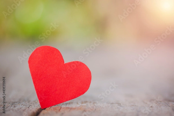 Fototapeta One red heart one love on wooden table for love concept and Valentine's Day on light bokeh background.