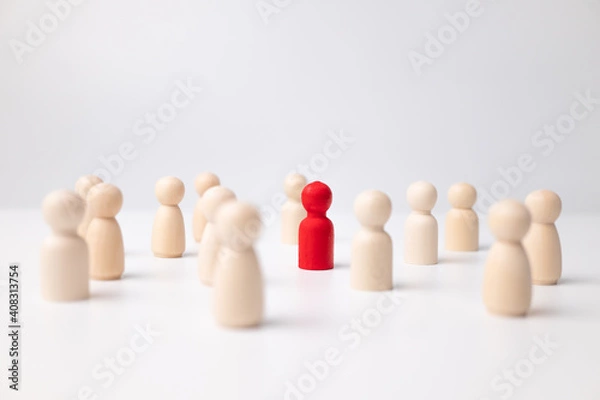 Fototapeta A wooden figure standing with a team to influence and empowerment. Concept of leadership, successful competition winner and Leader with influence and Social distancing for a new normal lifestyle