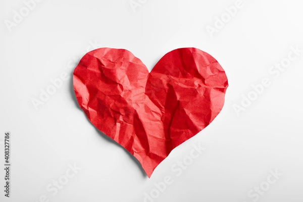 Fototapeta Crumpled red heart paper isolated on white background. Broken heart concept.