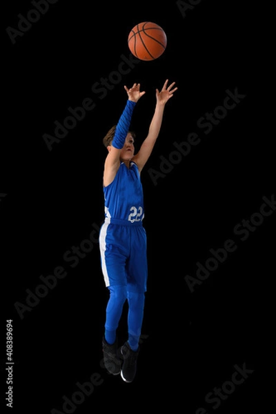 Fototapeta Young athletic boy playing in a game of basketball