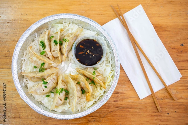 Obraz Dumplings or Potstickers with soy sauce in Aluminium Foil Container.