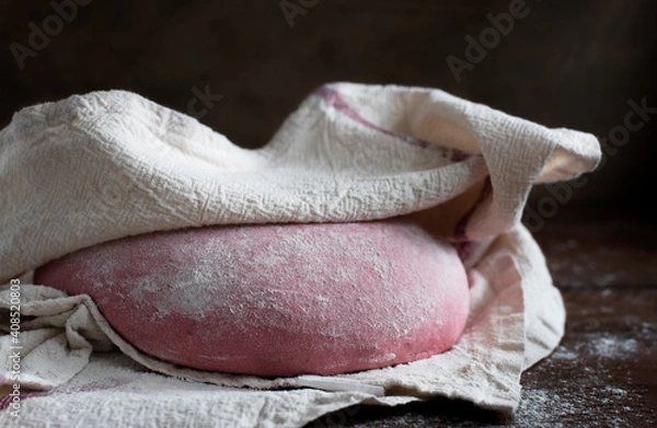 Fototapeta Pink beet root bread dough under cloth
