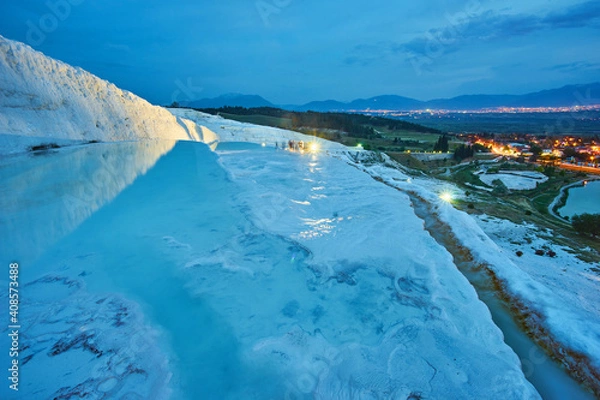 Obraz Pamukkale travertines in foreground. Sunset sky and illuminated houses