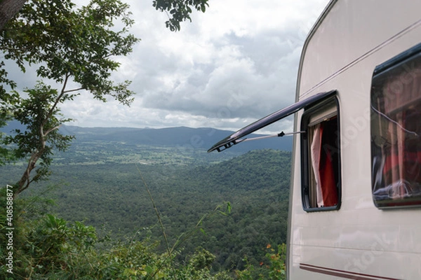 Obraz Close up part of camper van or caravan truck with window open parking at view point stop. Green relax freedom with nature mountain background