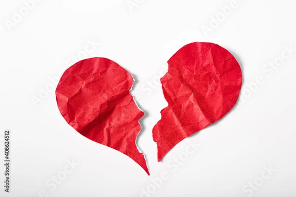 Fototapeta Pieces of crumpled and torn red heart shape paper isolated on white background. Broken heart concept.