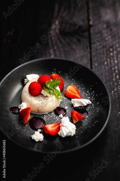 Fototapeta Vanilla Panna Cotta served with fresh Rutland strawberries, meringue shards and raspberry coulis