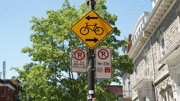 Fototapeta Montreal, QC- Canada - 6-24-2020: Parking challenge. Cycle sign and No Parking signs: left: Wednesdays from 7:00 - 8:00 AM, from Apr 1st to Dec 1st, right: 9:00 AM to 11:00 PM except for sector 13.