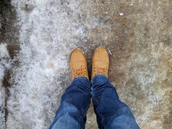 Obraz first person view man tilts his head looking for boots