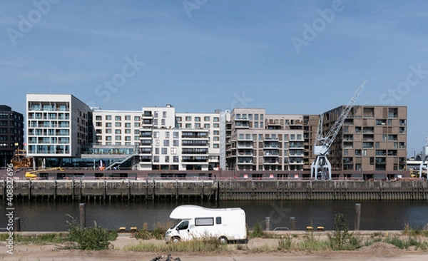 Fototapeta A caravan in front of modern Architecture as a symbol of travel in cities.
