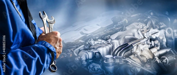 Obraz Auto mechanic working on car broken engine in mechanics service or garage.