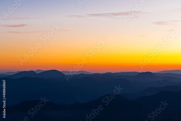 Fototapeta Scenic landscape of the mountains and the forest at sunset