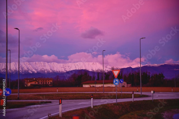 Fototapeta beautiful red-pink sunset and road in the fields